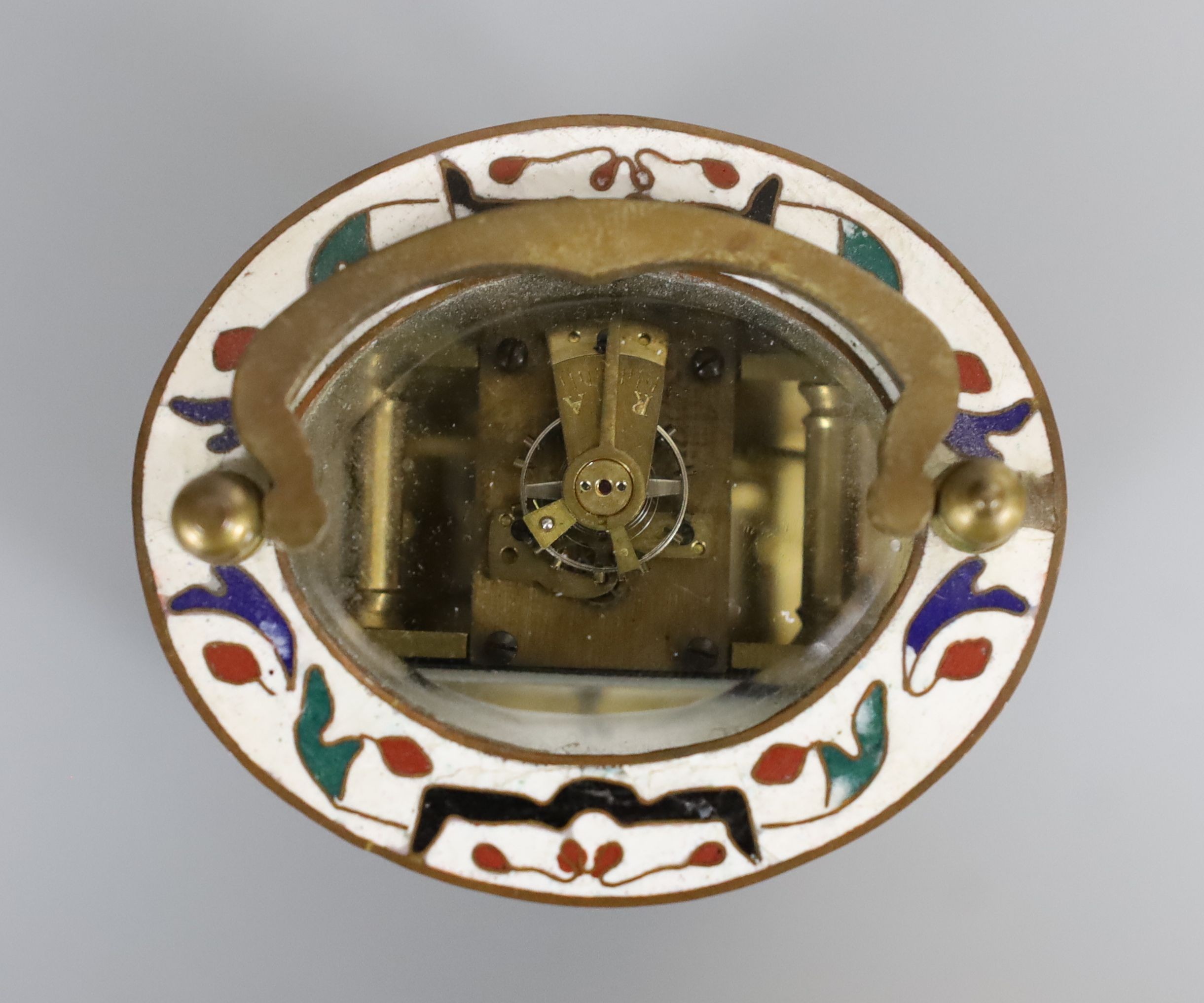 An oval brass and champleve enamel carriage timepiece, 9cm